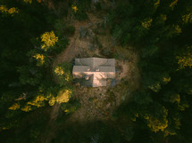 aerial view over a cabin in a forest 