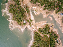 aerial view over a highway along a shoreline 