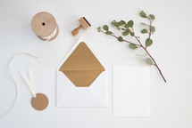 ribbon, envelope, gift tag, stamp, blank card, ribbon, eucalyptus twig 