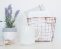 coffee mug, wire basket, and lavender house plant 