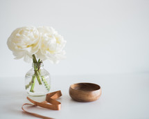 flowers in a vase and a wood bowl 