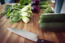 vegetables and knife on a cutter board 