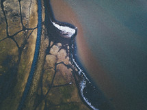 aerial view over a road and shore 