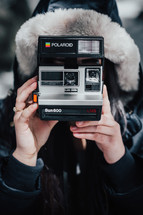 taking a picture with a polaroid camera 