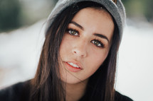 headshot of a young woman in a beanie 