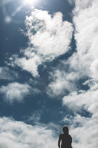 woman standing under a blue sky 