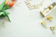 tulips, gold, paperclips, necklace, tape, white background 