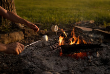 roasting marshmallows over a campfire 