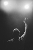 man with raised hand, worship on black 