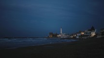  Lighthouse on the beach in the night 