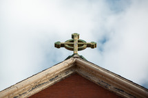 cross topper on a church roof 