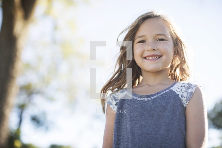 smiling girl child standing outdoors 