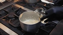 Cooking risotto meal in a metal pot 
