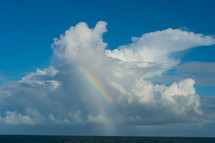 rainbow and clouds over the ocean 