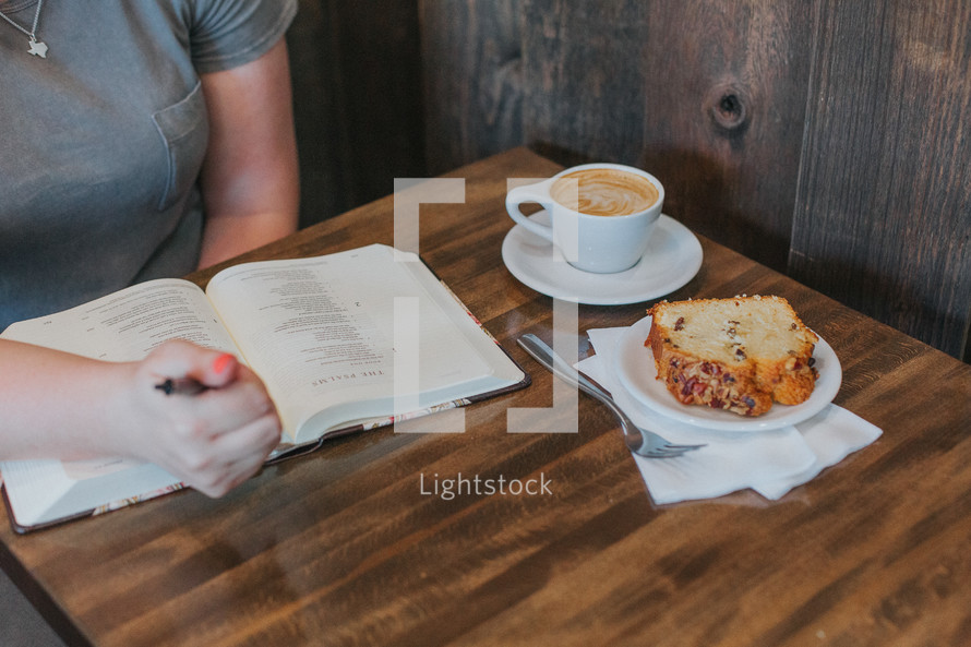 a woman reading a Bible over breakfast 
