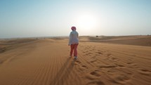 Woman Enjoying A Walk In The Windy Desert
