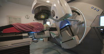 Patient getting Radiation Therapy Treatment inside a modern radiotherapy room