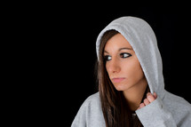 Distressed young woman in a hoodie.