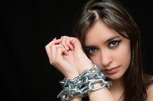 A woman with chained hands. 
