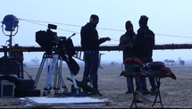film crew setting up in the desert 