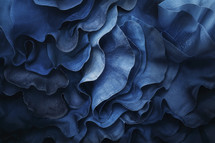 Elegant abstract art of undulating blue fabric textures with a satin sheen, capturing the fluidity and grace of draped material.