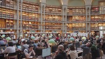 Paris, France - March 19, 2024: The Salle Ovale at the Bibliothèque Nationale de France, Richelieu an elegant oval room wood-paneled walls and beautiful ceiling, adorned with valuable book collection