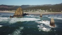waves crashing into small rock islands 