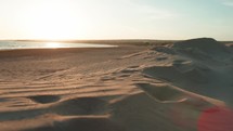 Beach with sand dunes at sunset