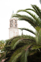 brick tower and palm fronds 