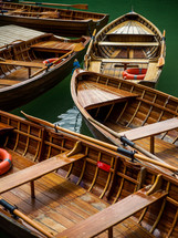 rowboats floating on green waters 