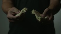man breaking bread 