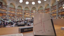 Paris, France - March 19, 2024: The Salle Ovale at the Bibliothèque Nationale de France, Richelieu an elegant oval room wood-paneled walls and beautiful ceiling, adorned with valuable book collection