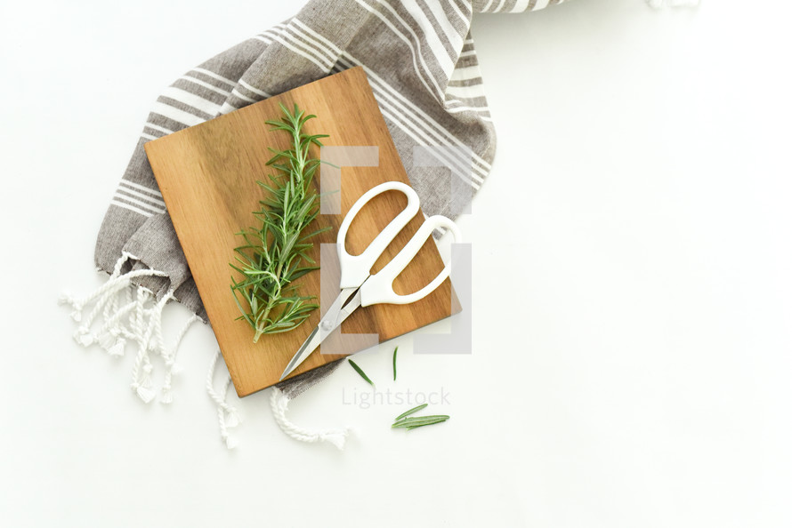 cutting board, rosemary, scissors, and, fabric 