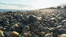 Grey pebble stones on the coast