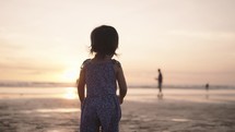 Happy Indonesian Toddler Walking, Dancing, Laughing, Enjoying Sunset at The Beach
