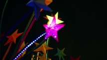 Stars With Light From An Amusement Park At Night 