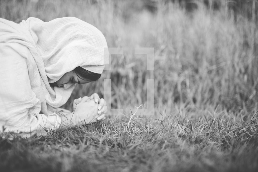 woman of biblical times kneeling in prayer