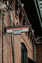 Trinity street sign on brick industrial building in the Distillery District in Toronto, Canada.