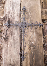 metal cross on wood 