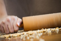 rolling pin making peanut crumbs 
