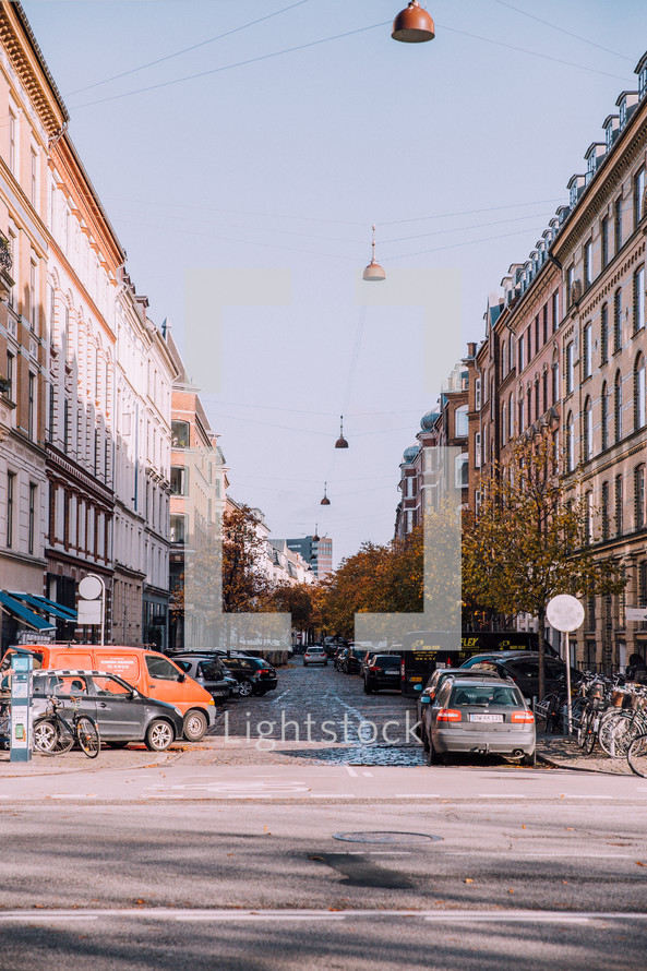 cars parked along a cobblestone street in Copenhagen 