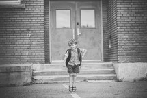 a boy entering a school 