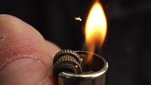 A lighter ignited and its flame shot in slow motion.