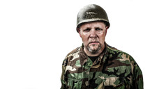 Soldier in camouflage uniform with helmet on white background.