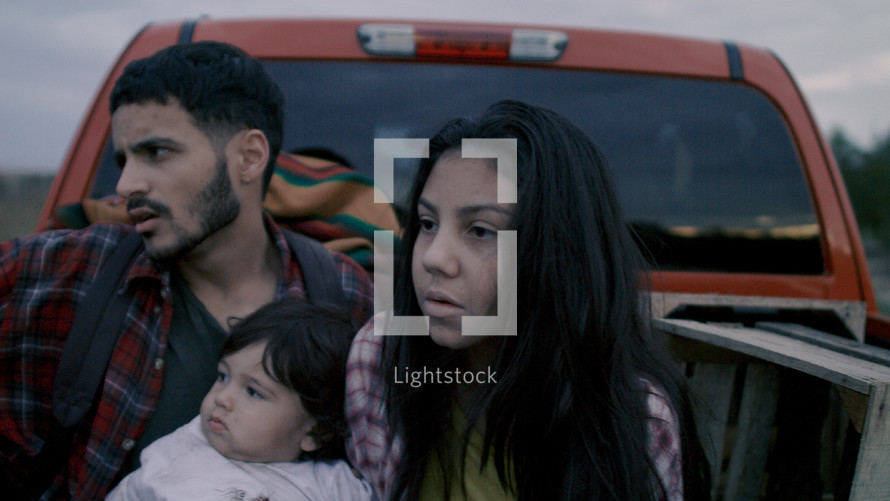 migrant family in the back of a truck 