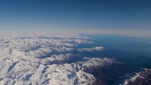 aerial view over snow capped mountains - Alps 