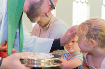 child receiving a blessing durning communion 