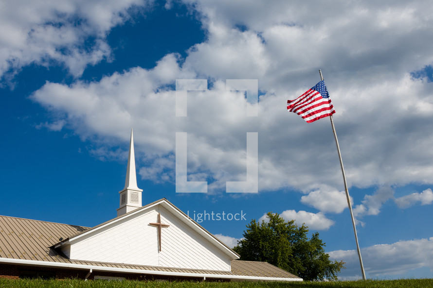 an American flag in front of a church