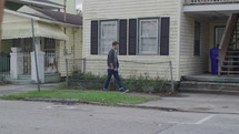 man walking down a sidewalk 