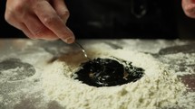 Chef Mixes The Dough With Flour Eggs And Cuttlefish Ink Food